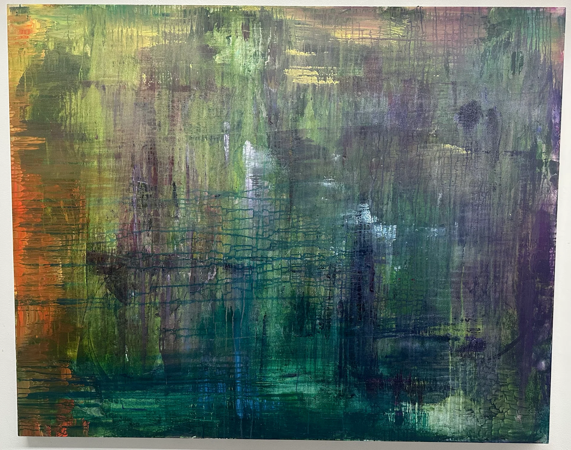 An abstract painting that is mainly green with purple, yellow, blue and orange, and drips in a grid like pattern.
