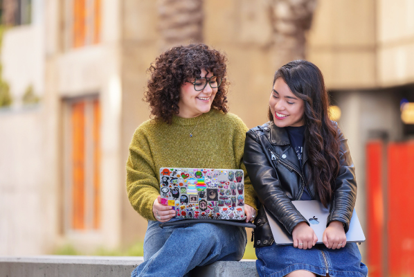 Two students talking together outside