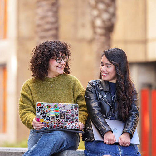 Students discussing something on a computer