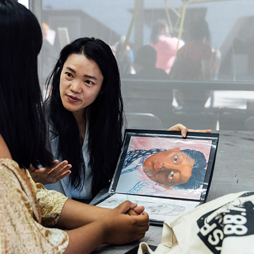 Student and instructor discussing portfolio