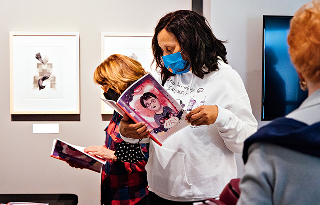Guests view Otis College student work at the Wende Museum