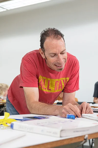 Photo of Enoch Davis teaching a student