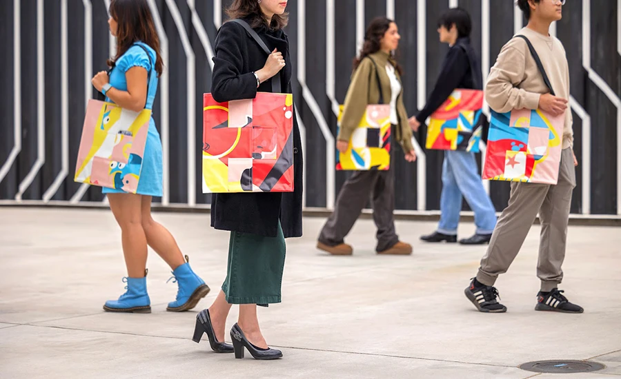 Design Lab students who worked on the tote bag project showcase their work on campus