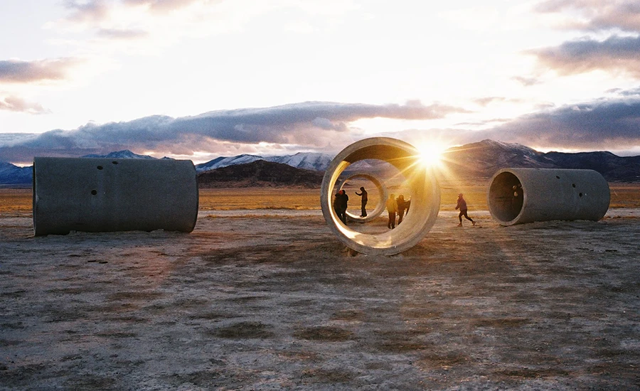 Photo of students with concrete installation in the desert by Ian James