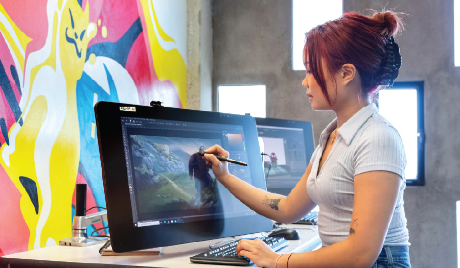 Student drawing at a computer at Otis College