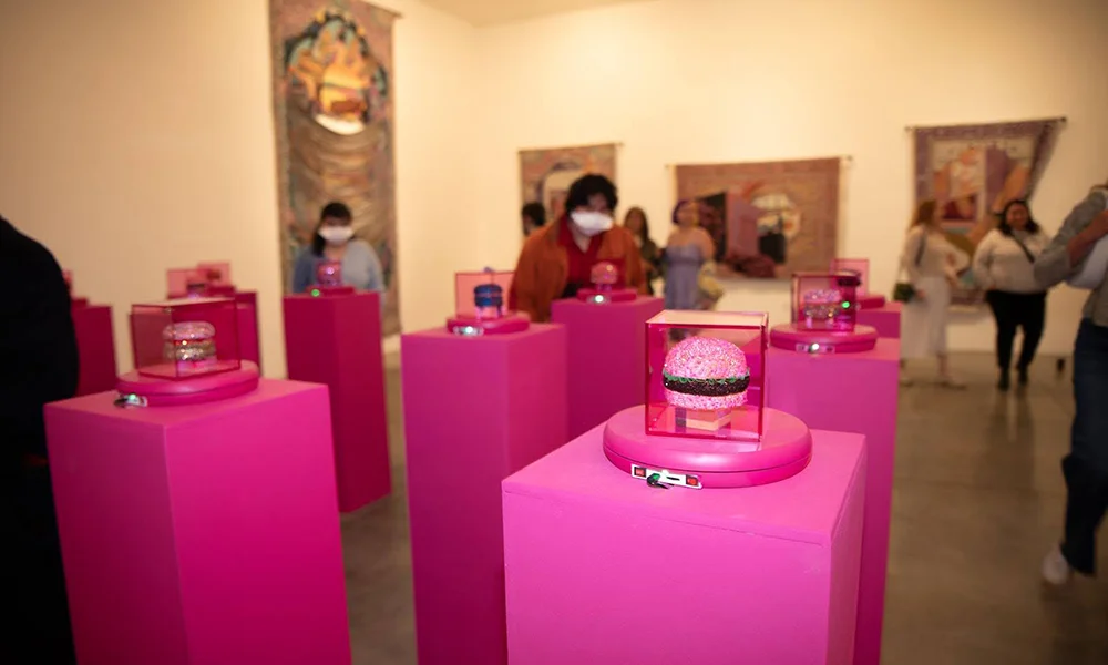 Guests visit Vita Kari’s MFA Thesis Show, which included sparkly hamburger sculptures.