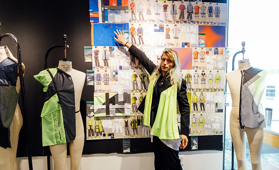 A Fashion Design student presents sketches to mentors from Nike.