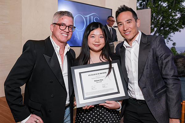 Otis College student Philana Trieu receives an award from Mattel executives.