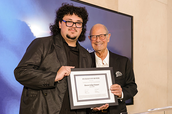 Otis College student Silverio Indigo Vazquez receives an award from Cliff Einstein.