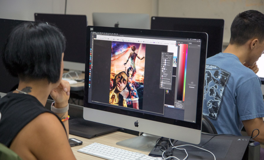Student designing digital art in class