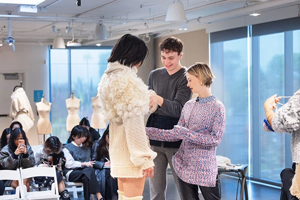Mentor Ida Lamberton, right, head of women’s ready-to-wear at clothing brand FRAME, during a fitting session with Otis College Fashion Design students