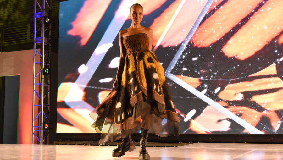 Model wearing a colorful dress on a catwalk