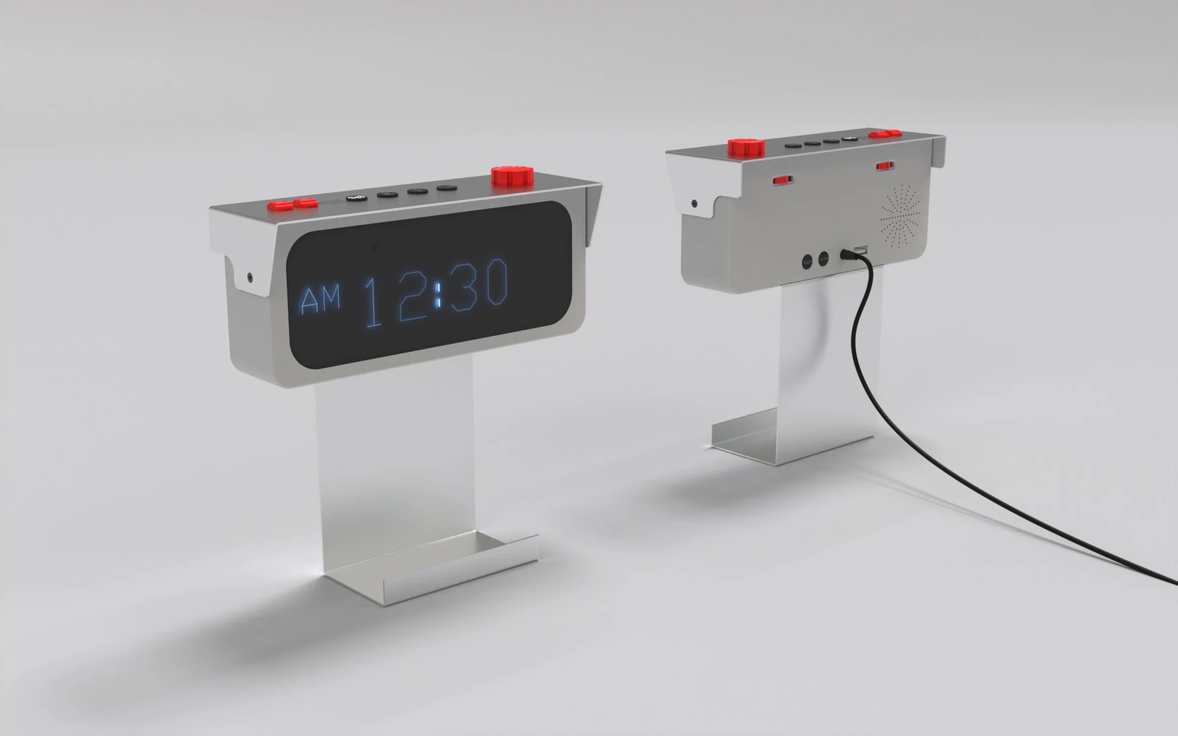 This image shows a pair of modern, minimalist alarm clocks called "Sentra Alarm Clock", designed to resemble old CCTV cameras. Both clocks have a sleek, industrial look, made of a combination of folded sheet metal and injection-molded plastic. One clock is facing forward, displaying a digital time of 12:30 AM in a cool, blue LED font on a black screen. The other clock is turned around, revealing the back, which features a small speaker grille, control buttons, a USB charging port, and a black power cable plugged in. The design is clean and geometric, with a rectangular body mounted on a flat, upright metal stand that has a wide, stable base. The clocks also feature red dials and buttons on top, adding a pop of color and a bit of retro-futuristic character to the otherwise silver and black aesthetic.