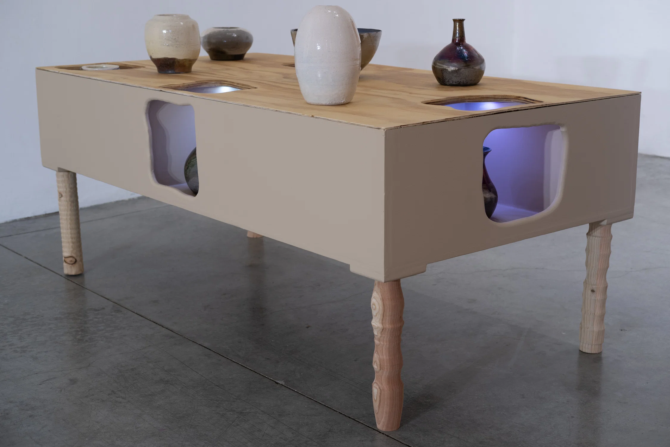 low table with pockets displaying ceramics