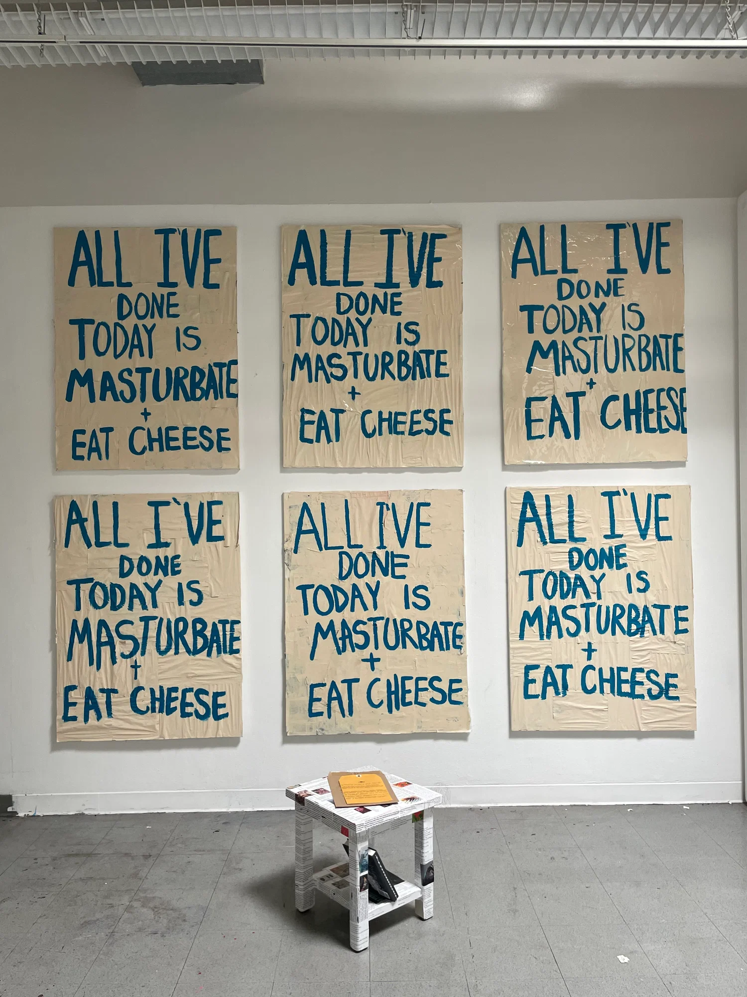 6 seemingly identical collaged and painted canvas's covered with resin with text reading "All I've done today is masturbate and eat cheese."