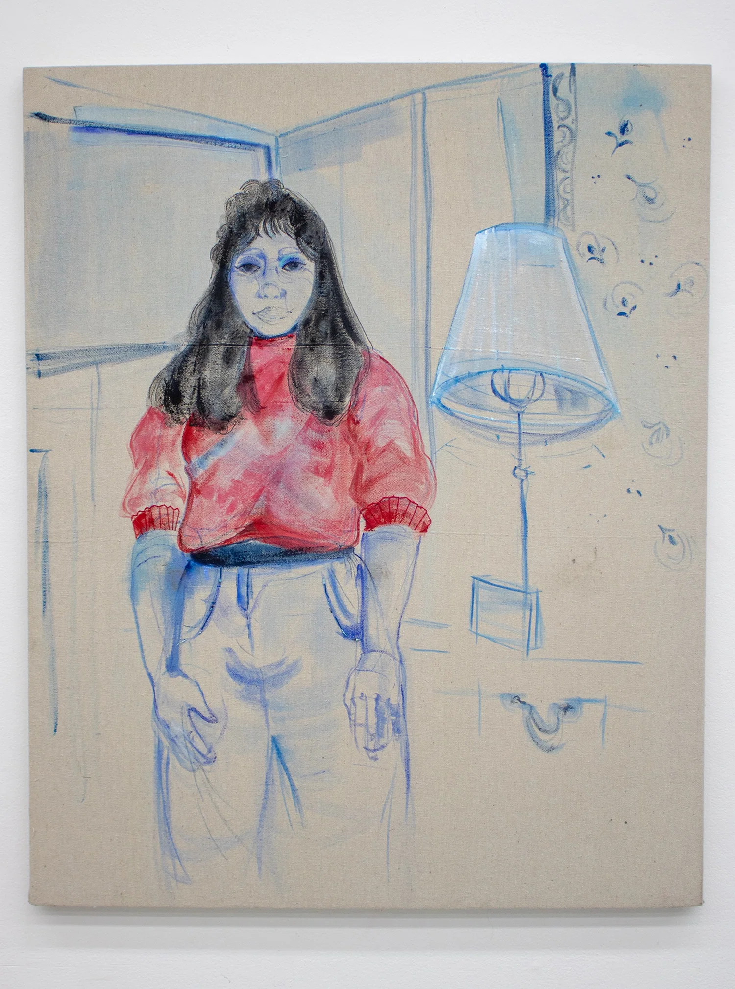 A linen canvas painted with acrylic and embroidered. The image is of a women in a red sweater standing in a room next to a lamp.
