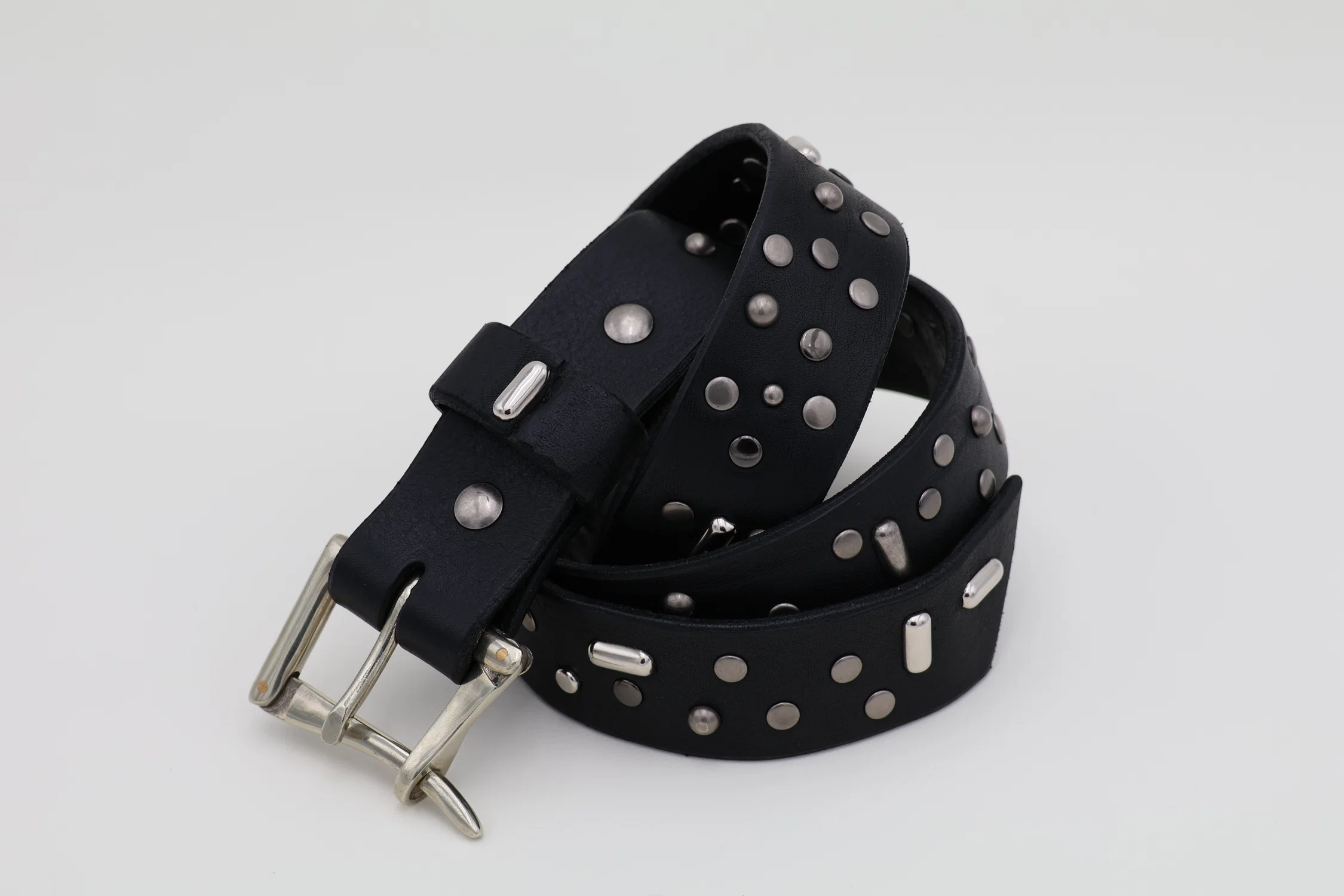 The Night Sky Belt, a belt with more than 100 rivets and studs in different sizes and finishes on a bison and vegetable tanned leather strap with a quick release buckle.
