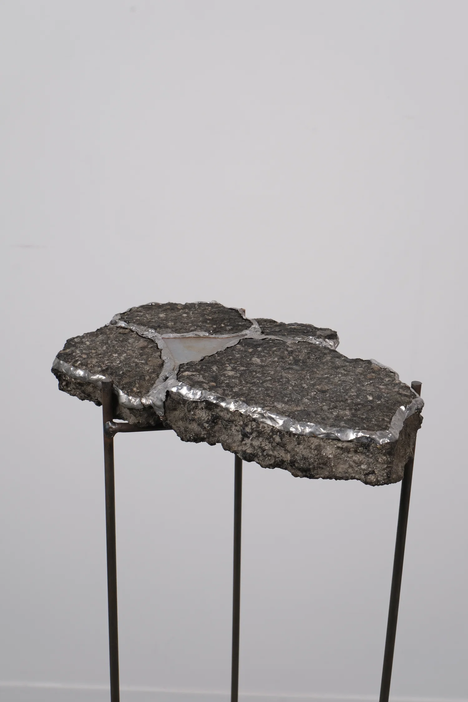 asphalt mended with solder and glass