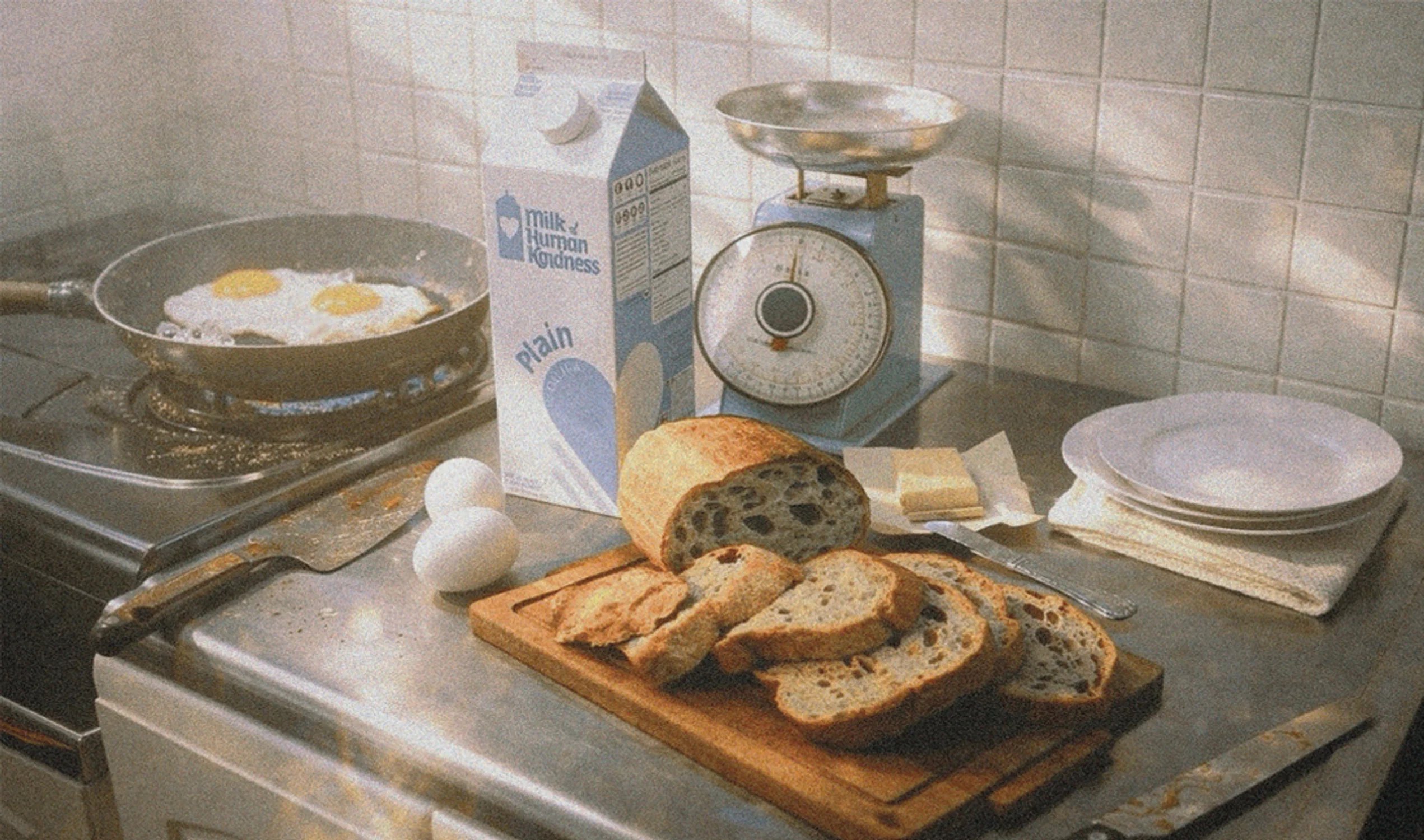 A cozy kitchen scene with fried eggs on the stove, sliced bread on a cutting board, a carton of milk, butter, and a vintage kitchen scale on the counter.