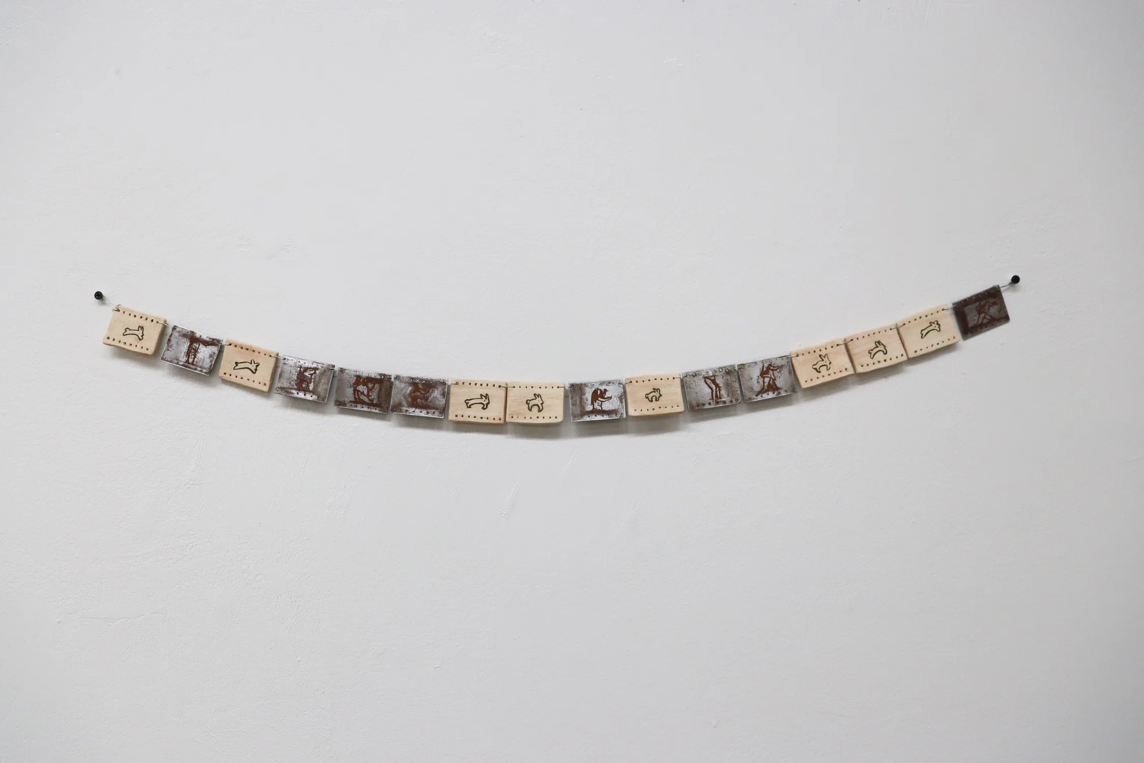 GIRLS ON FILM!, 2025 Steel, ceramic, wire, glaze, rust 6 in x 36 in