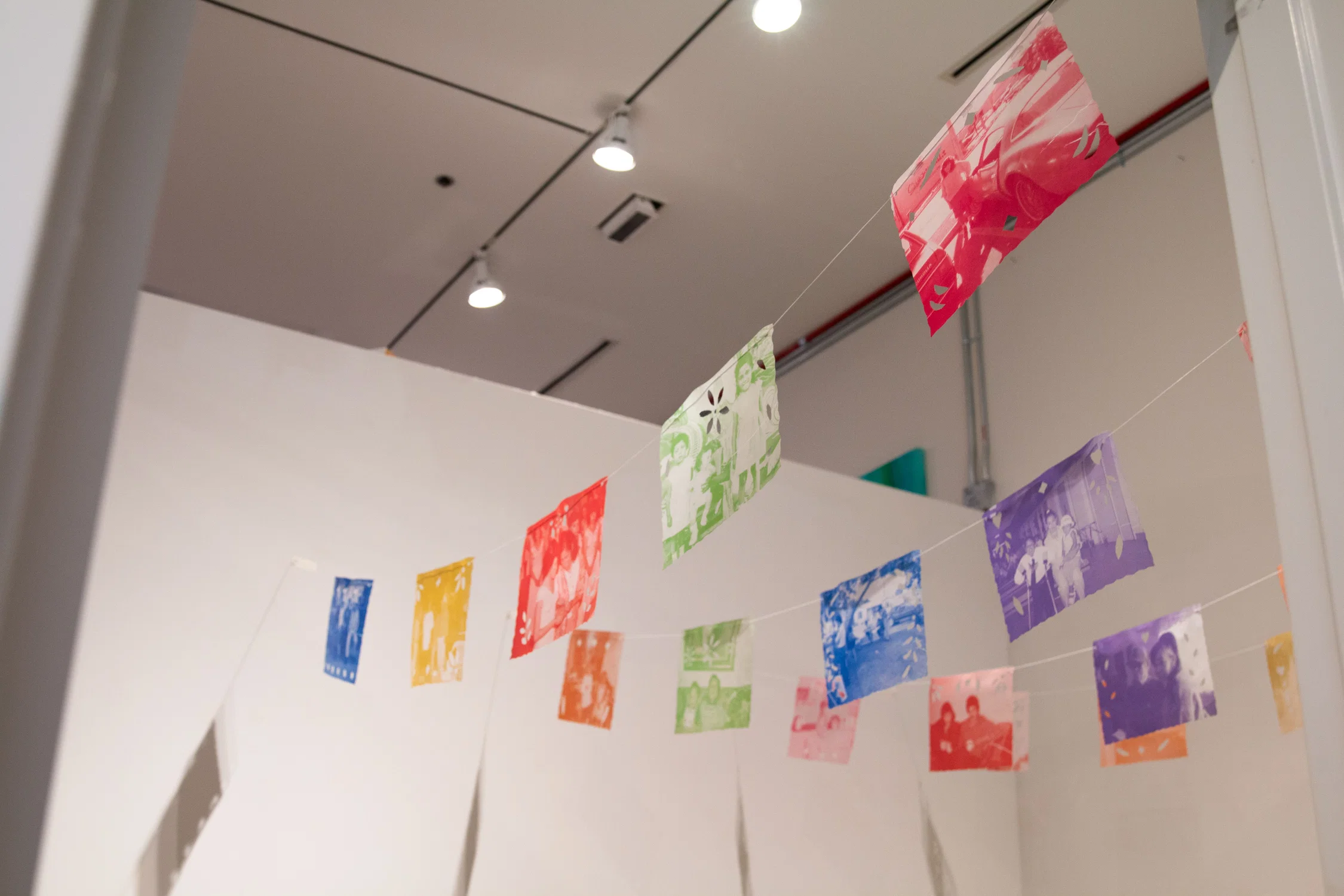 Installation of Papel Picado made from family photographs.