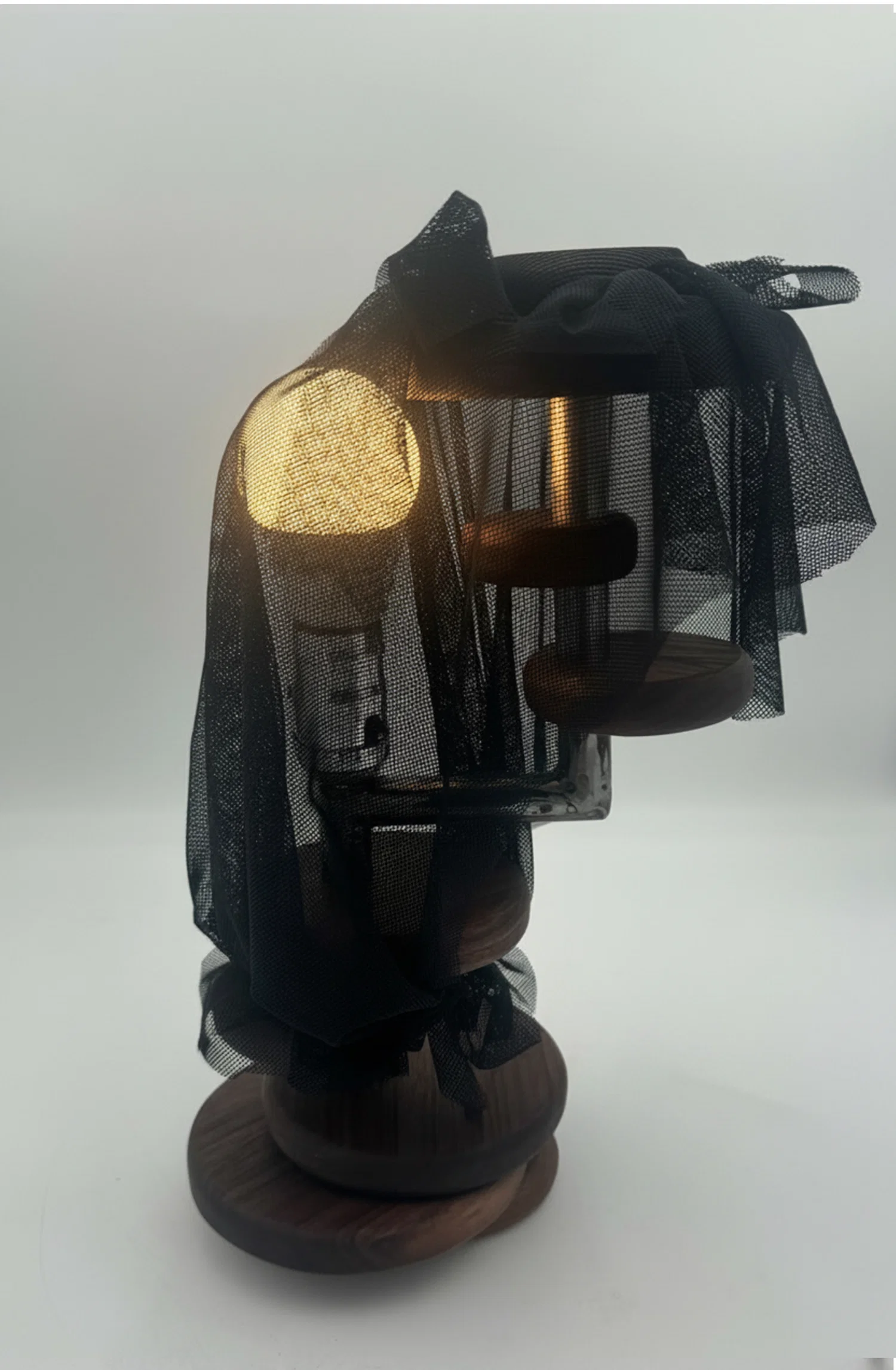 A sculptural light that explores contrast between exposure and concealment. Wrapped in a translucent mesh, it diffuses the source into a soft, ambient glow, shifting the focus from the bulb to the atmosphere it creates.