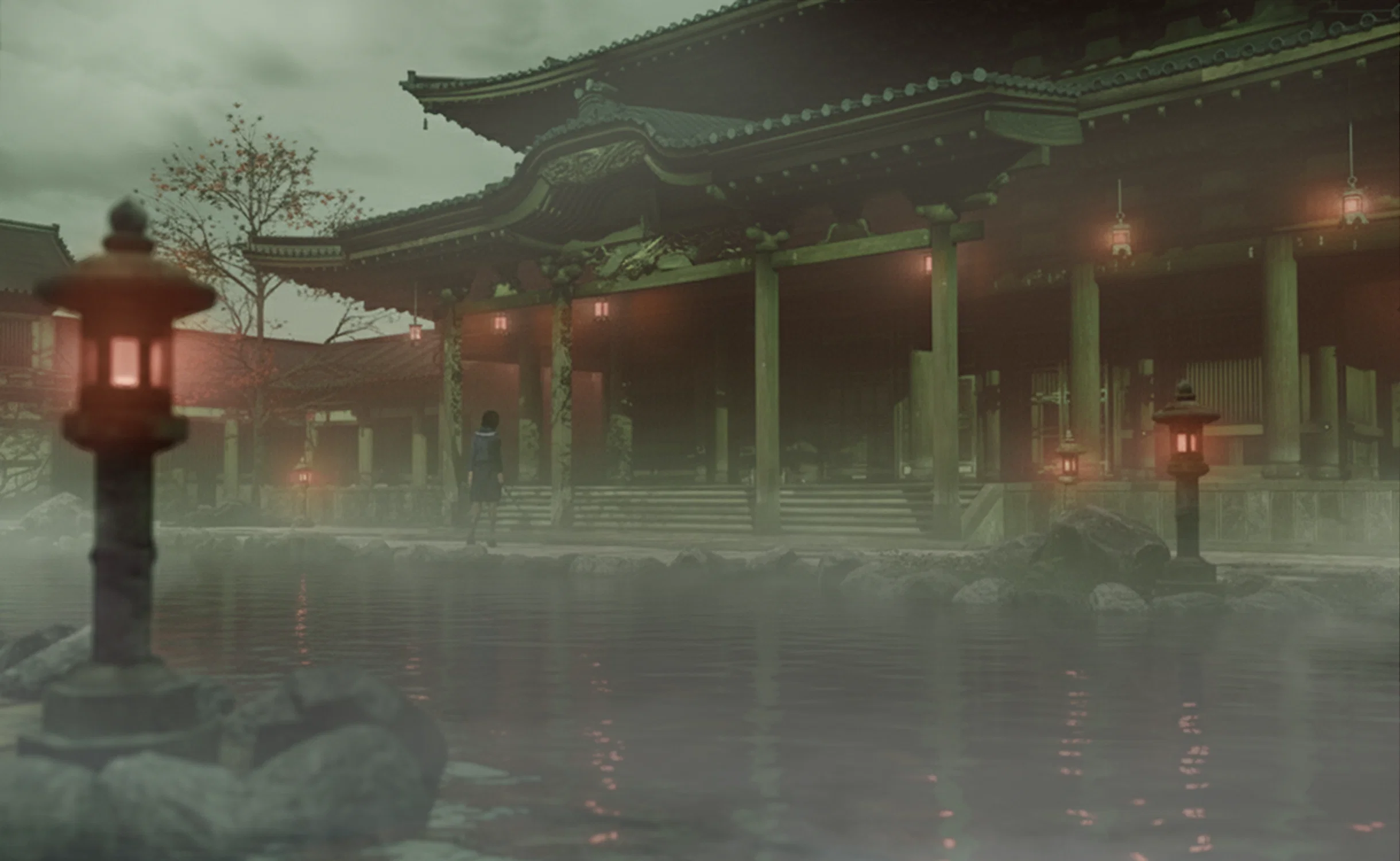A lone figure in a school uniform stands before a massive, ornate Japanese temple at night. The scene is shrouded in thick fog, with glowing stone lanterns and hanging lights reflecting in the calm surface of a pond in the foreground.