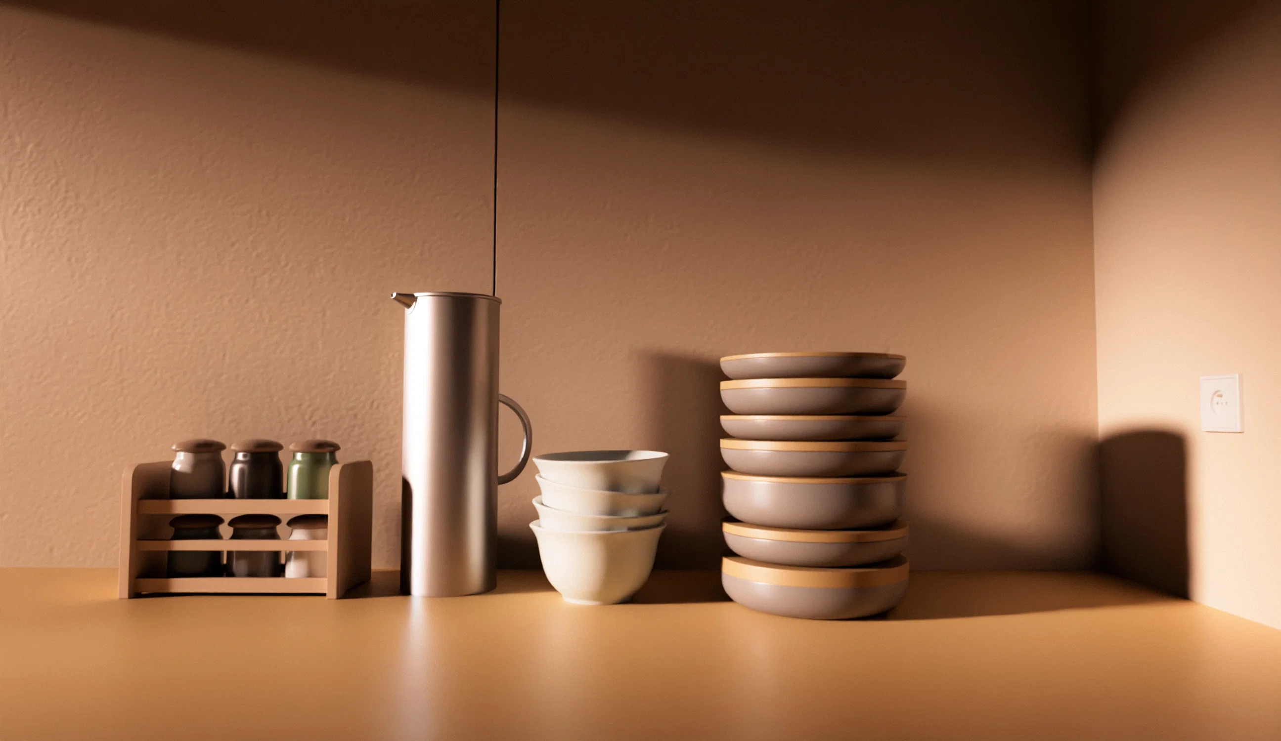 A minimalist kitchen counter setup against a warm, tan-colored wall. The scene features a small wooden rack with spice jars, a tall silver pitcher, a stack of white bowls, and a tall stack of grey plates with wooden undersides. Sharp, geometric shadows are cast across the wall and counter from an overhead light source, creating a clean and modern aesthetic.