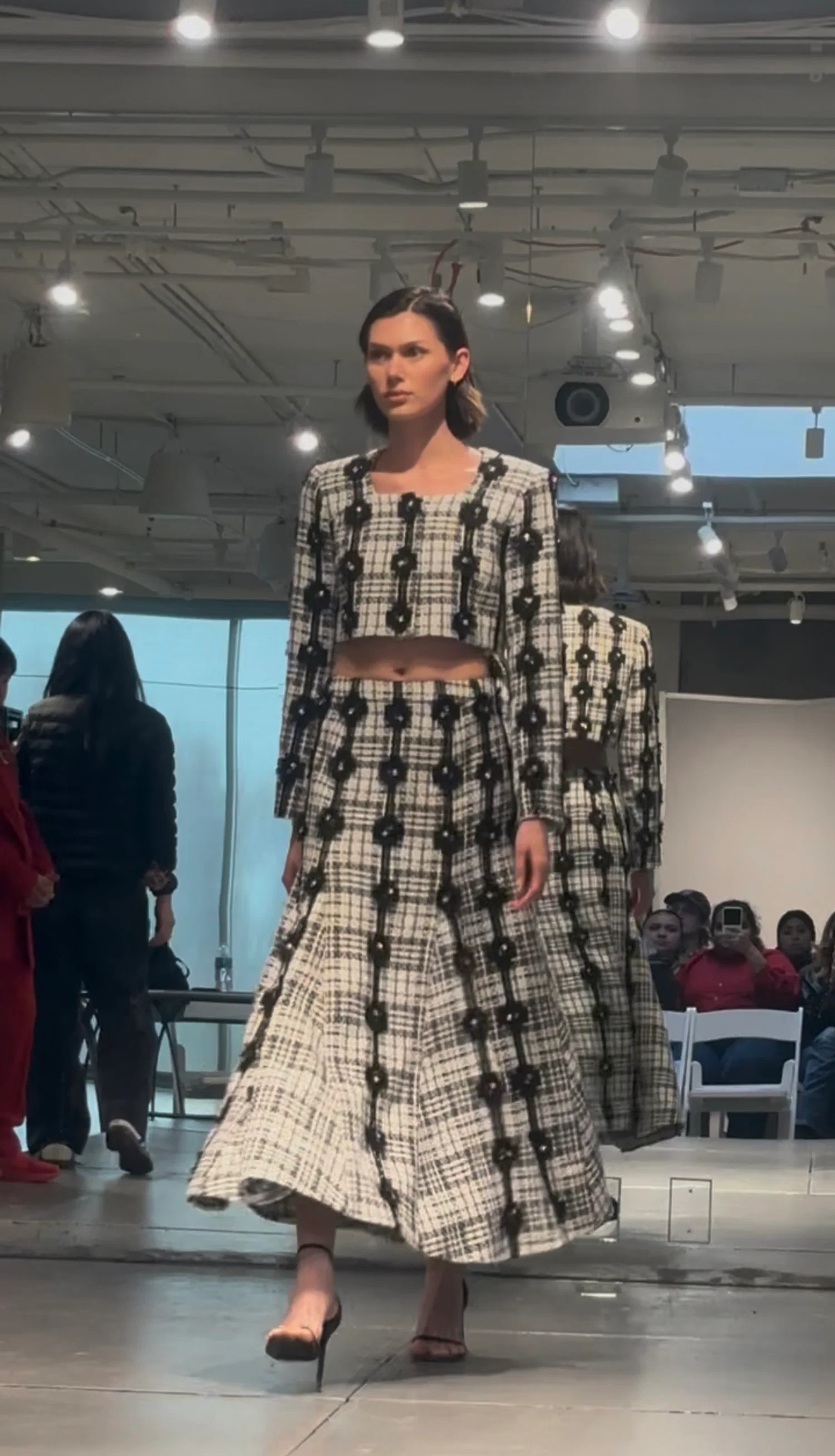 Model wearing a cropped jacket and flared skirt