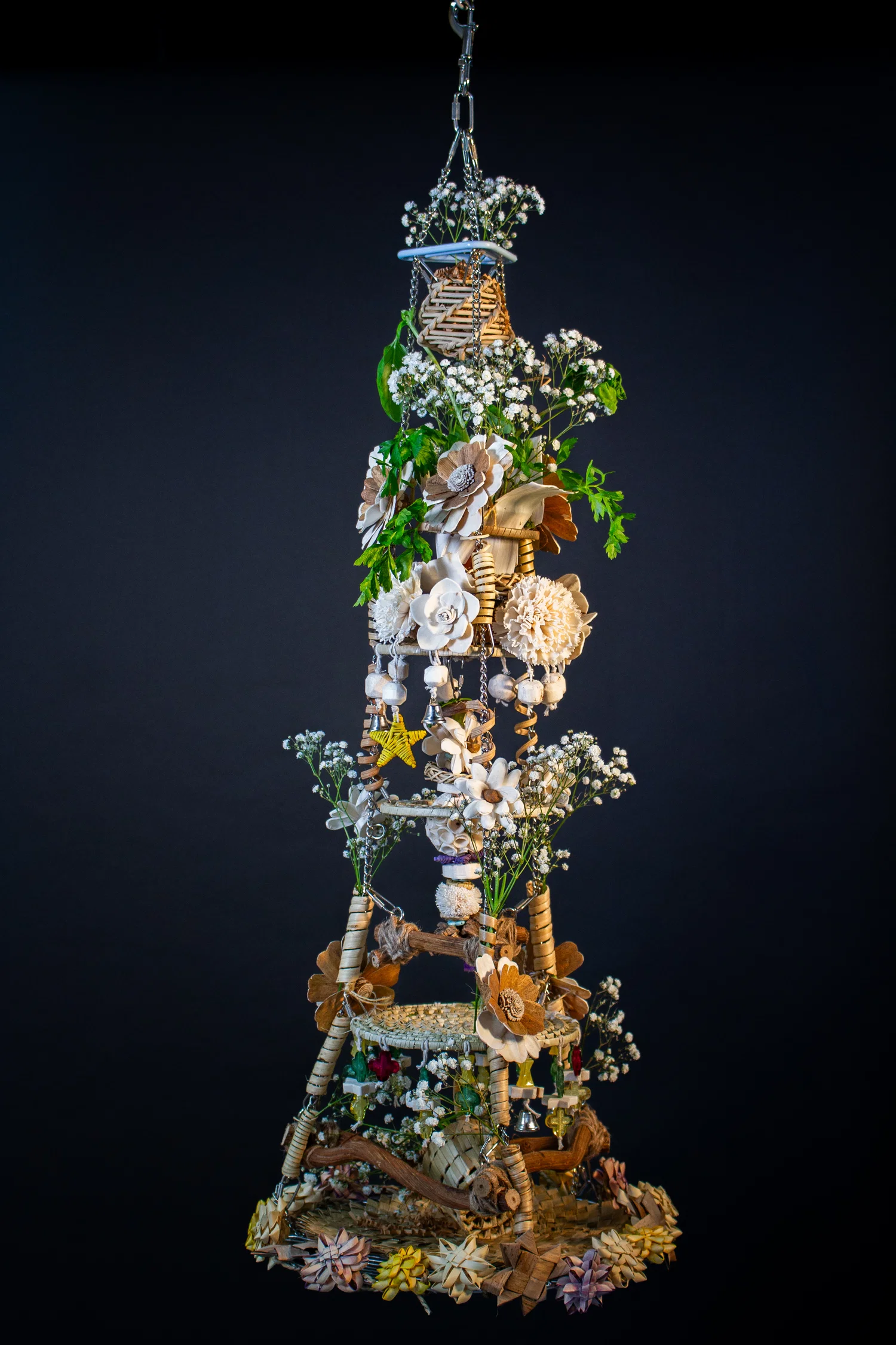 A three dimensional hanging sculpture made mostly of organic materials and metal.