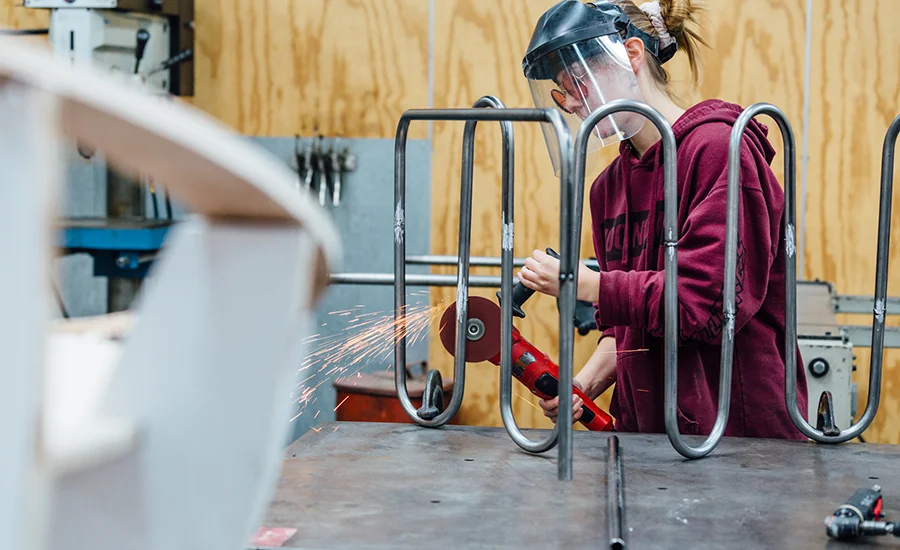Student working with metal