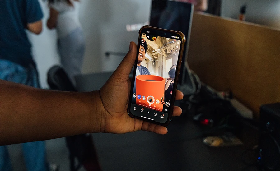 Student testing snap lens project on phone