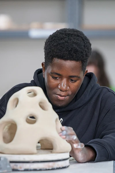 Student working on a sculpture