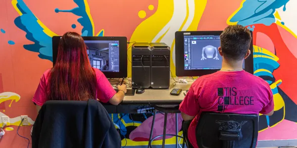 Two students working at computers