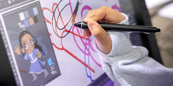 student working on characted design on computer