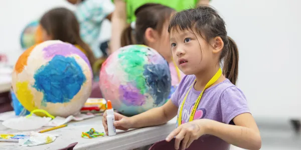 Female Summer Youth Camp student working on he cosmic creation
