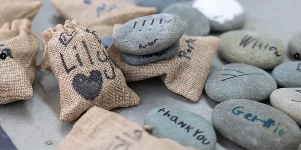 Painted, signed and graphed stones and burlap sacks