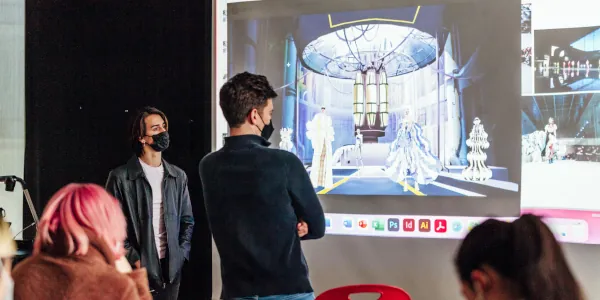 Four studenrs study a projected game image showing strong perspective