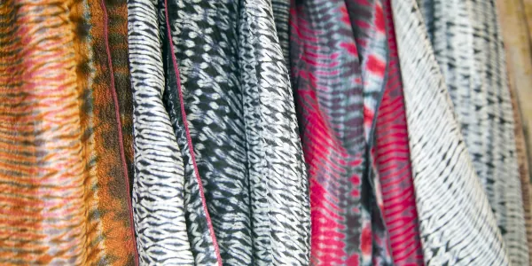 A collection of fabric bolts showing various surface designs