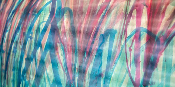Fabric surface with many curved teal and pink lines