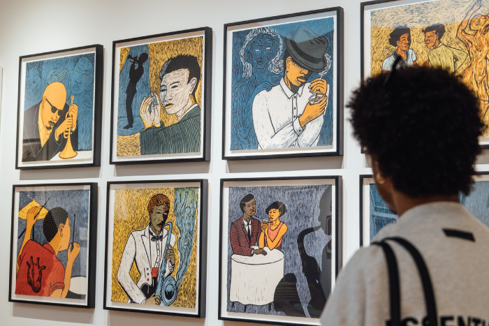 Student looking at artwork on the wall