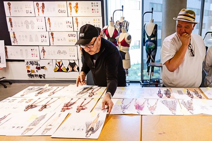 Instructors Aaron Paule (left) and Paul Keng (right) reviewing the student's illustrations after their presentation.