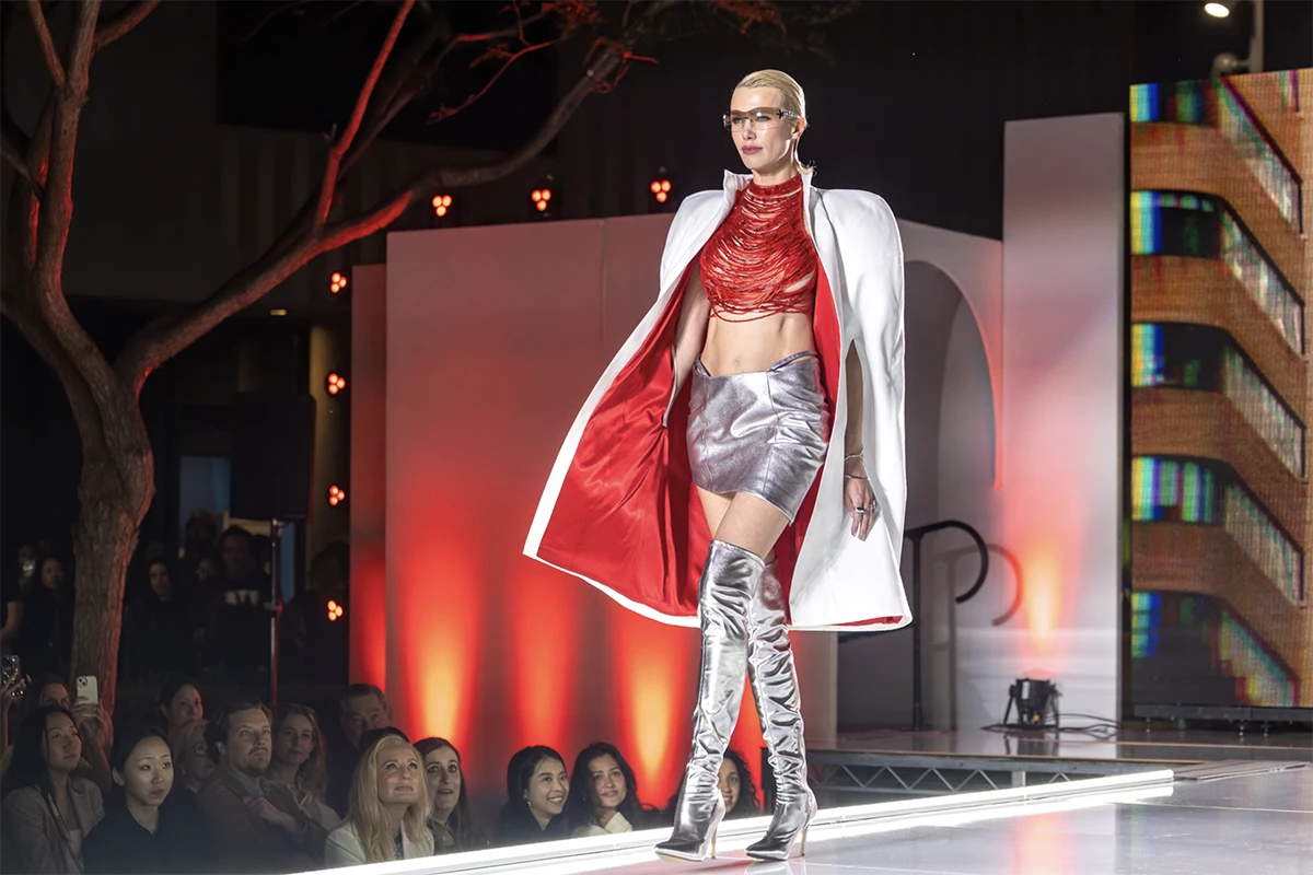 activision archetypes - model wearing silver boots, silver skirt, red top and white coat.