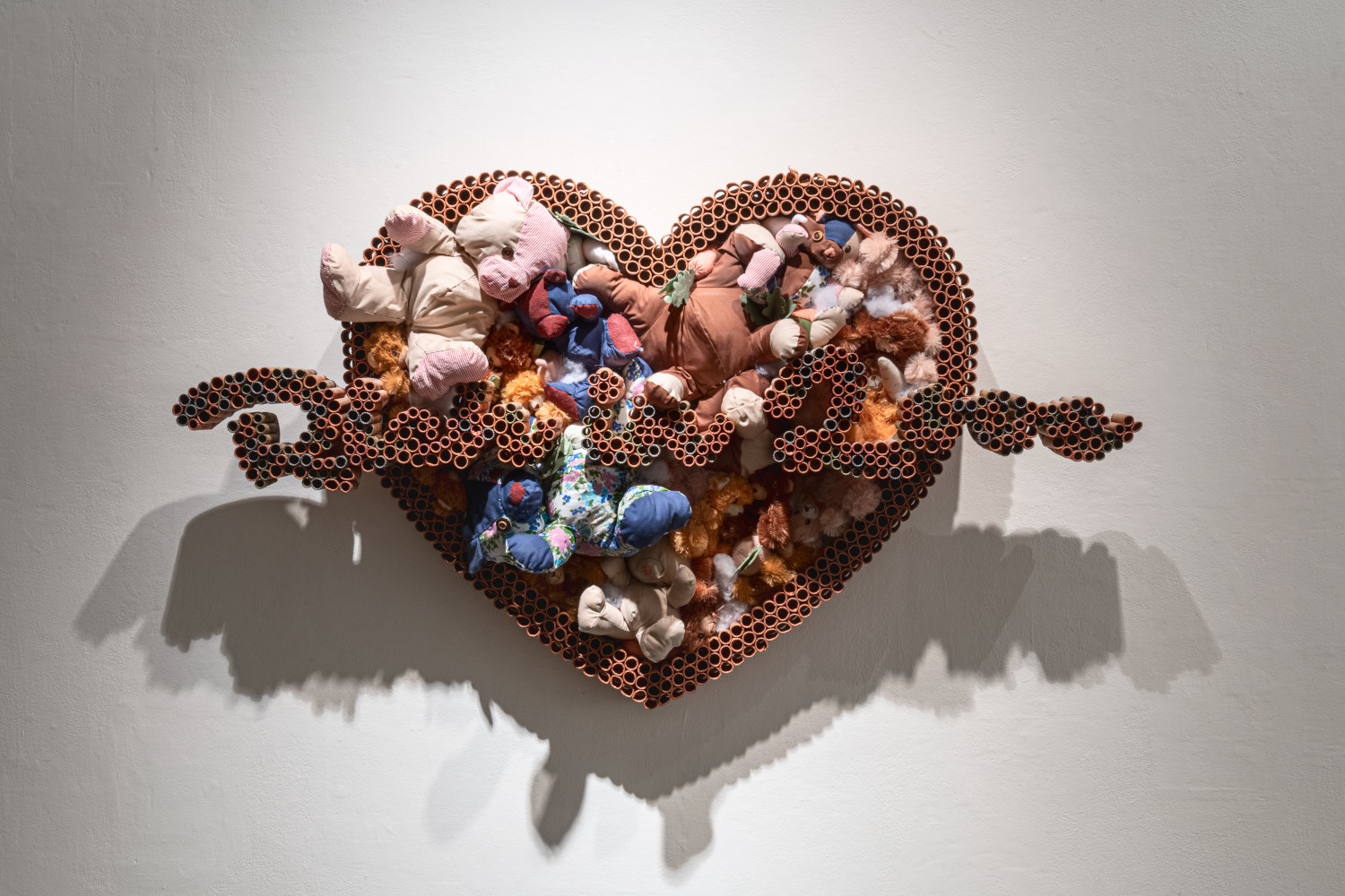 Sayer Delk artwork of Teddy bears, coin rolls and MDF board in a heart  shape