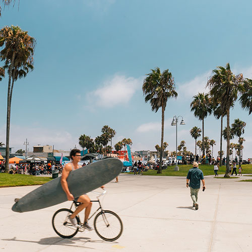 Outdoors in Los Angeles, photo of bicyclist with surfboard 