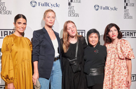 Five women pose in front of an photo-op backdrop at the Los
    Angeles Fashion Week
