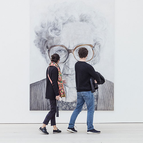 Museums in Los Angeles, photo of two people in front of painted portrait