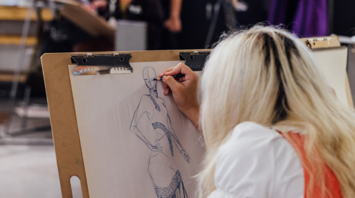 Student drawing on an easel