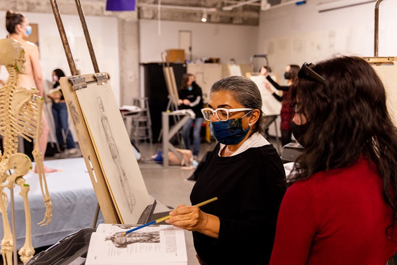 Marjan Harmozi, left, Area Head of Drawing Form and Drawing Studio, works with a Foundation student