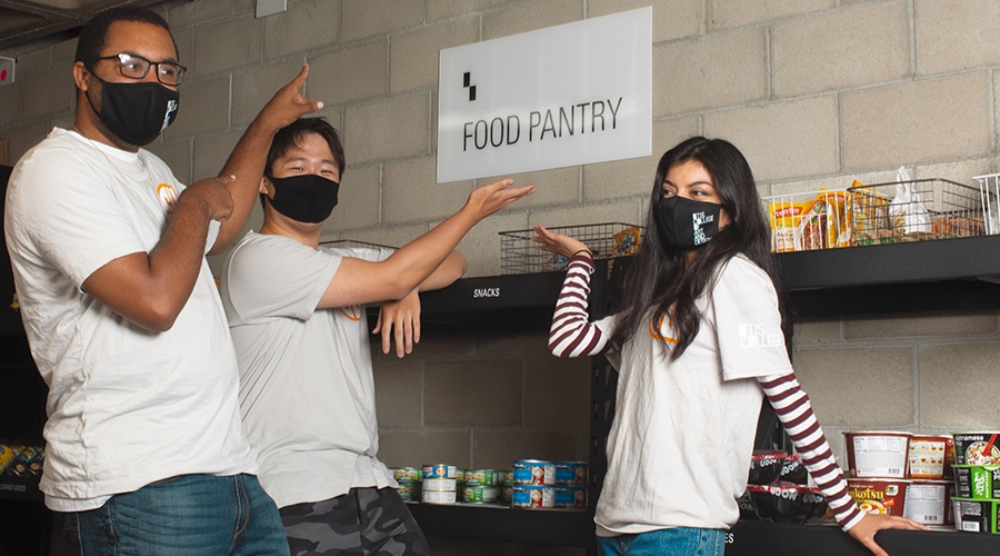 Otis College students restock the Food Pantry.